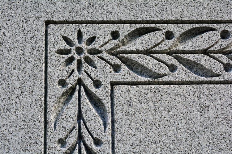 Rock of Ages Blue Gray granite detail carving on headstone