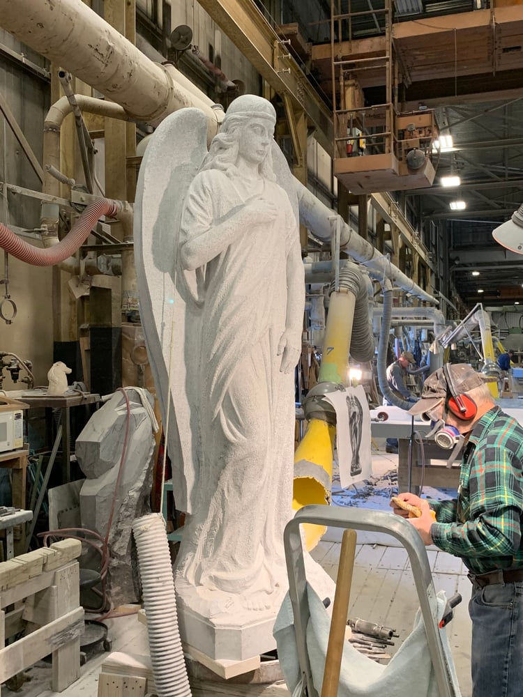 Master Rock of Ages sculptor works on crafting an angel sculpture out of Bethel White granite