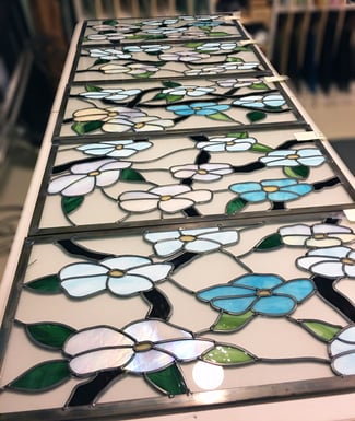 Sue Bee Glass designed this stained glass piece of Magnolia Trees to wrap around the building