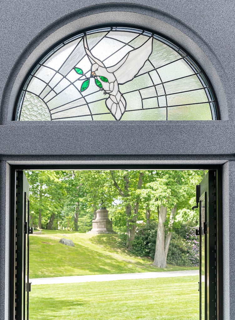 Inside view from the Chambers family private mausoleum with a stained glass window depicted a dove by Sue Bee Glass