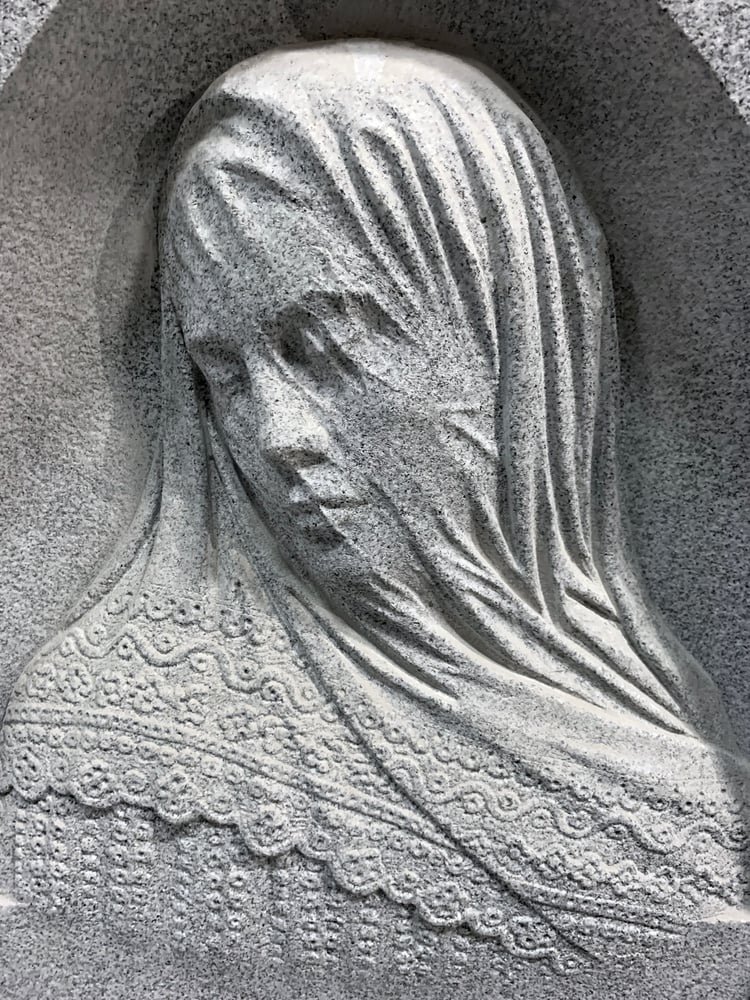 Finely carved details of a granite headstone 
