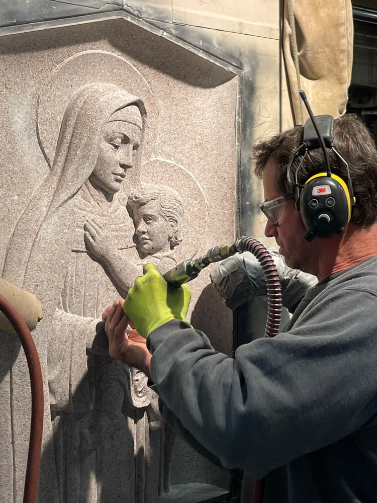 Stone artisan carves details into granite memorial 