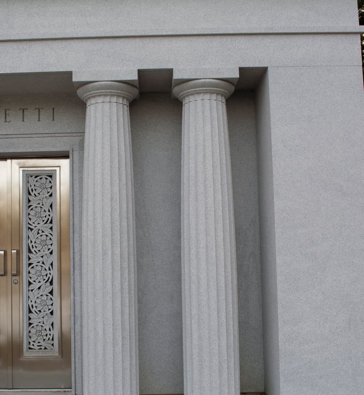 Grecian and Roman Doric style columns sculpted into mausoleum design
