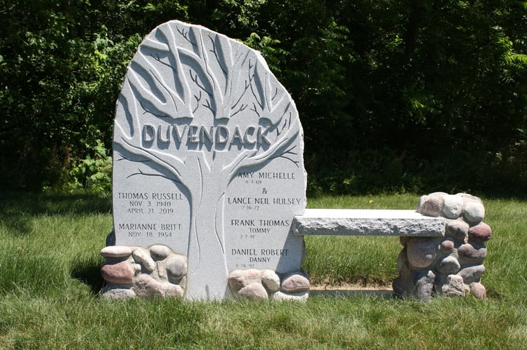 Blue Gray granite headstone memorial with tree carving relief with sentimental and symbolic meaning