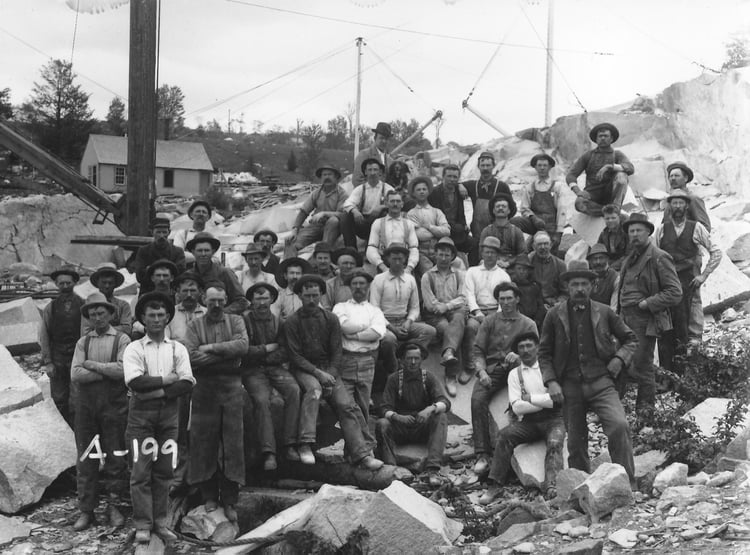 Group of men on granite blocks